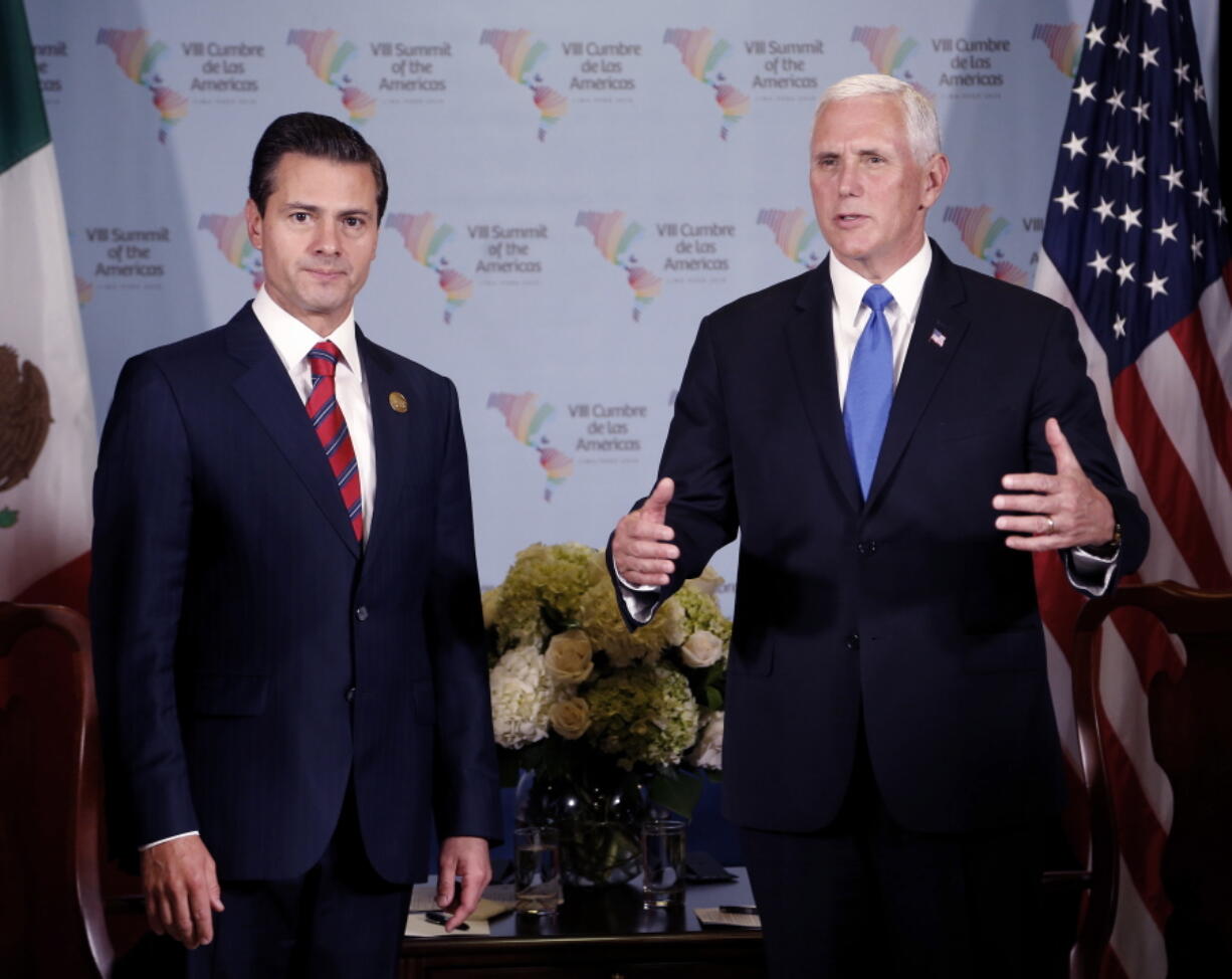 U.S. Vice President Mike Pence, right, speaks Saturday at a bilateral meeting with Mexico’s President Enrique Pena Nieto at the Americas Summit in Lima, Peru.