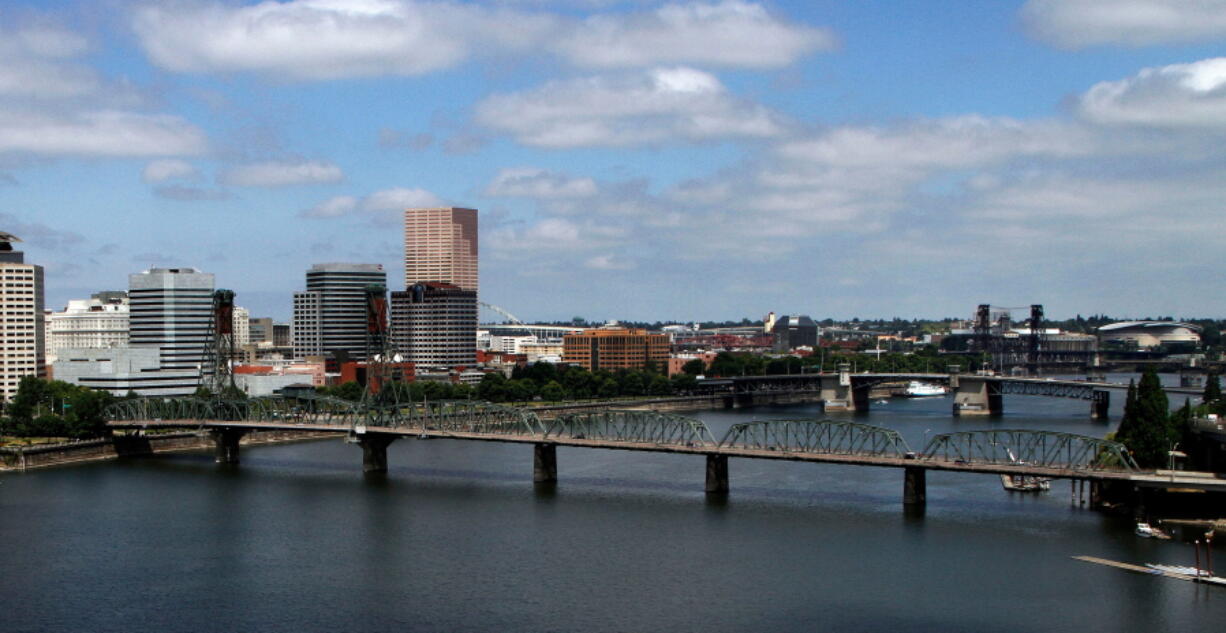 FILE - In this Aug. 1, 2012 file photo, the downtown skyline is shown on the west bank of the Willamette River in Portland, Ore. Officials say the backers of an effort to bring a professional baseball team to Portland have submitted formal proposals to buy sites to potentially build a stadium.