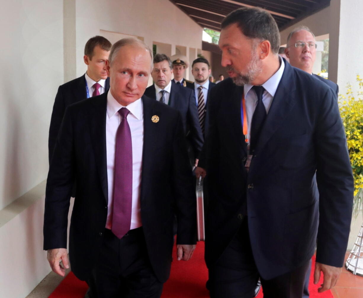 File-This Nov. 10, 2017, file photo shows Russia’s President Vladimir Putin, left, and Russian metals magnate Oleg Deripaska, right, walking to attend the APEC Business Advisory Council dialogue in Danang, Vietnam. The United States punished dozens of Russian oligarchs and government officials on Friday, April 6, 2018, with sanctions that took direct aim at President Putin’s inner circle, as President Donald Trump’s administration tried to show he’s not afraid to take tough action against Moscow. Seven Russian tycoons, including aluminum magnate Deripaska, were targeted, along with 17 officials and a dozen Russian companies, the Treasury Department said.