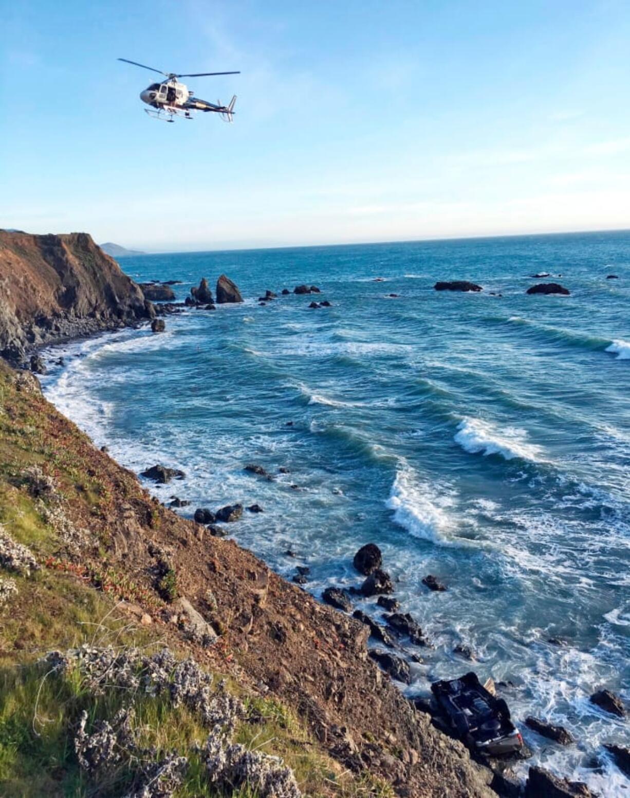 FILE - In this March 27, 2018, file photo provided by the California Highway Patrol a helicopter hovers over steep coastal cliffs near Mendocino, Calif., where a vehicle, visible at lower right, plunged about 100 feet off a cliff along Highway 1, killing all passengers. The SUV was carrying the Hart family, from Woodland, Wash. On Tuesday, April 17 the Mendocino County Sheriff’s Office said that one of the bodies recovered has been identified as being Ciera Hart, a missing member of the Hart family.