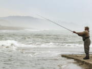 Phil Pope casts out into Siletz Bay as the high tide comes in Sept. 14, 2015, while fishing for salmon in Lincoln City, Ore. One year after a crash in Klamath River salmon returns sparked a full-scale closure, sport anglers off the Southern Oregon coast are on track for a 100-day chinook season from mid-May through late August.