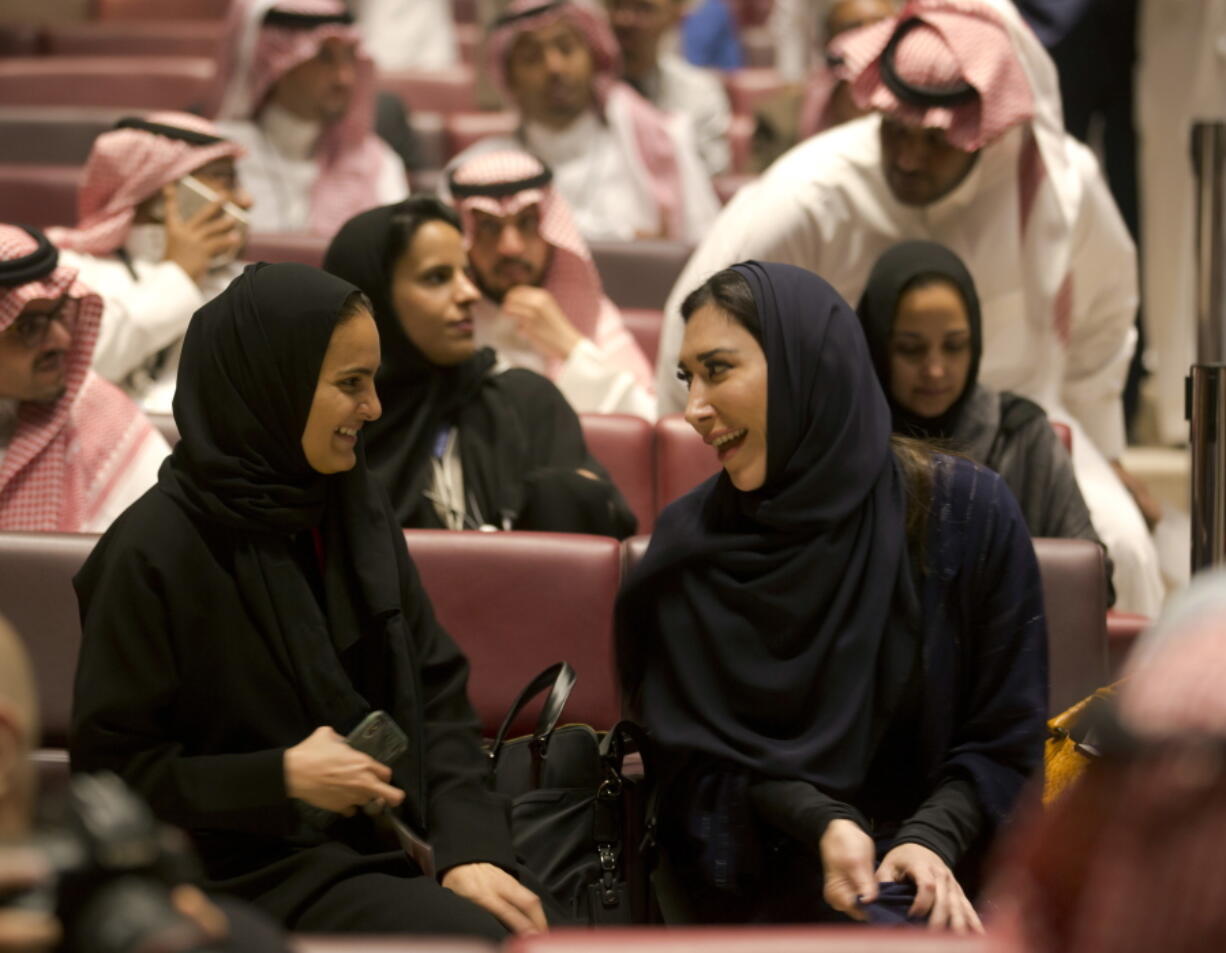 Visitors laugh as they attend a cinema theatre at an invitation-only screening, at the King Abdullah Financial District Theater, in Riyadh, Saudi Arabia, on Wednesday. Saudi Arabia held a private screening of the Hollywood blockbuster “Black Panther” to herald the launch of movie theaters in the kingdom.