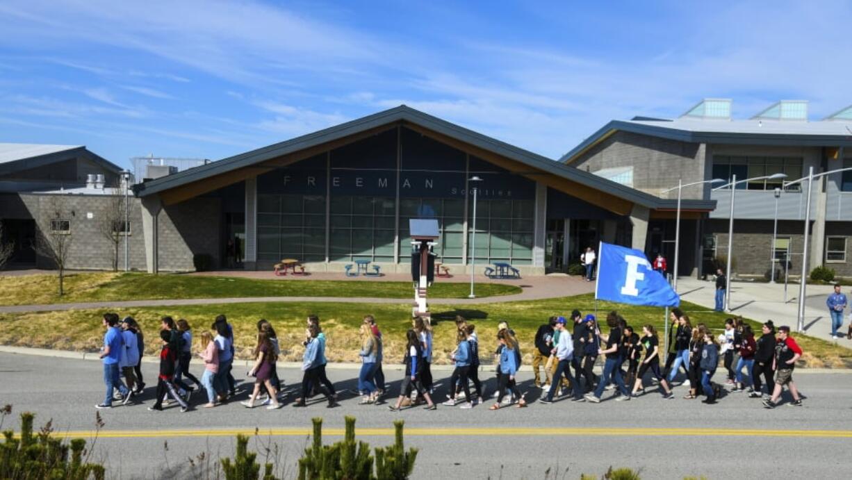 Freeman High School students march from their school to the football field to participate in the nationwide walkout to protest gun violence Friday in Freeman, Wash.