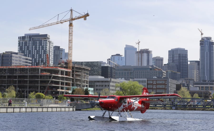 A Harbour Air seaplane taxis Wednesday on Lake Union in Seattle before taking off for Vancouver, B.C.