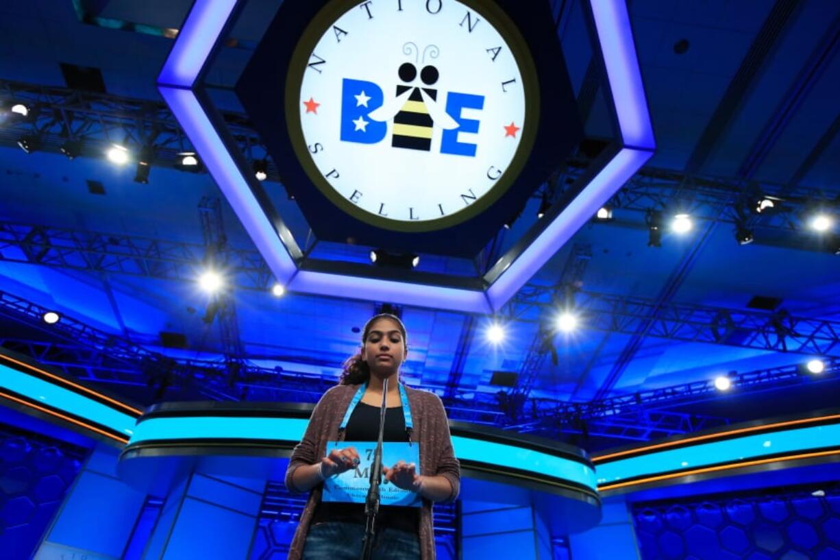 FILE - In this June 1, 2017 file photo, Mira Dedhia, 13, from Western Springs, Ill., uses an imaginary keyboard to correctly spell her word during the finals of the 90th Scripps National Spelling Bee, in Oxon Hill, Md. A new wild-card program has expanded the field at the Scripps National Spelling Bee from fewer than 300 spellers to more than 500.