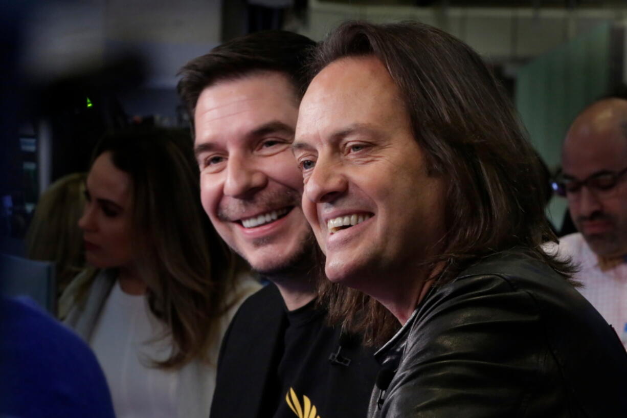 Sprint CEO Marcelo Claure, left, and T-Mobile CEO John Legere are interviewed on the floor of the New York Stock Exchange, Monday, April 30, 2018. To gain approval for their $26.5 billion merger agreement, T-Mobile and Sprint aim to convince antitrust regulators that there is plenty of competition for wireless service beyond Verizon and AT&T.