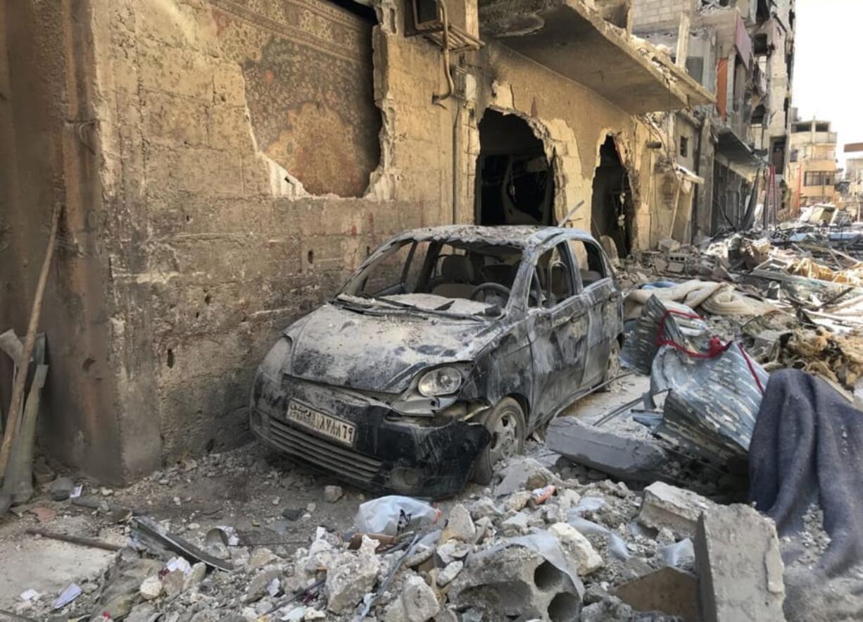 Rubble lines a street in Douma, the site of a suspected chemical weapons attack, near Damascus, Syria, on Monday. Faisal Mekdad, Syria’s deputy foreign minister, said on Monday that his country is “fully ready” to cooperate with the fact-finding mission from the Organization for the Prohibition of Chemical Weapons that’s in Syria to investigate the alleged chemical attack that triggered U.S.-led airstrikes.