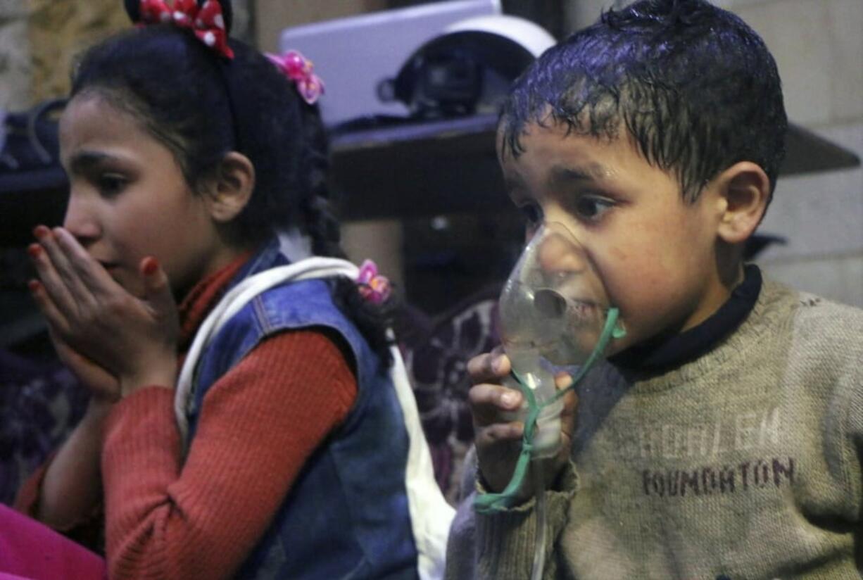 A child receives oxygen through a respirator following an alleged poison gas attack in the rebel-held town of Douma, near Damascus, Syria, in this image released Sunday.