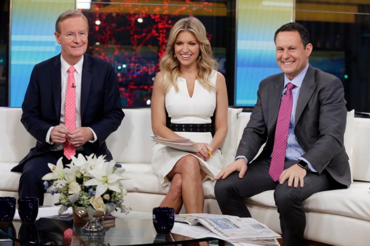 “Fox & Friends” co-hosts, from left, Steve Doocy, Ainsley Earhardt and Brian Kilmeade appear on their set in New York.