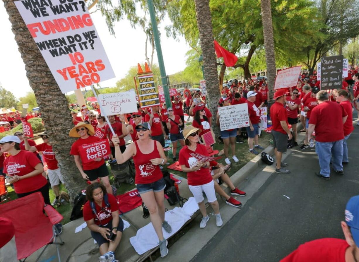 FILE - In this April 27, 2018 file photo, teachers rally outside the Capitol in Phoenix, in a series of strikes across the nation over low teacher pay. The president of the American Federation of Teachers is coming to Phoenix on Monday to support Arizona teachers' call for additional school funding. Randi Weingarten will be holding a news conference next to the state Capitol and also she is scheduled to speak at a rally.