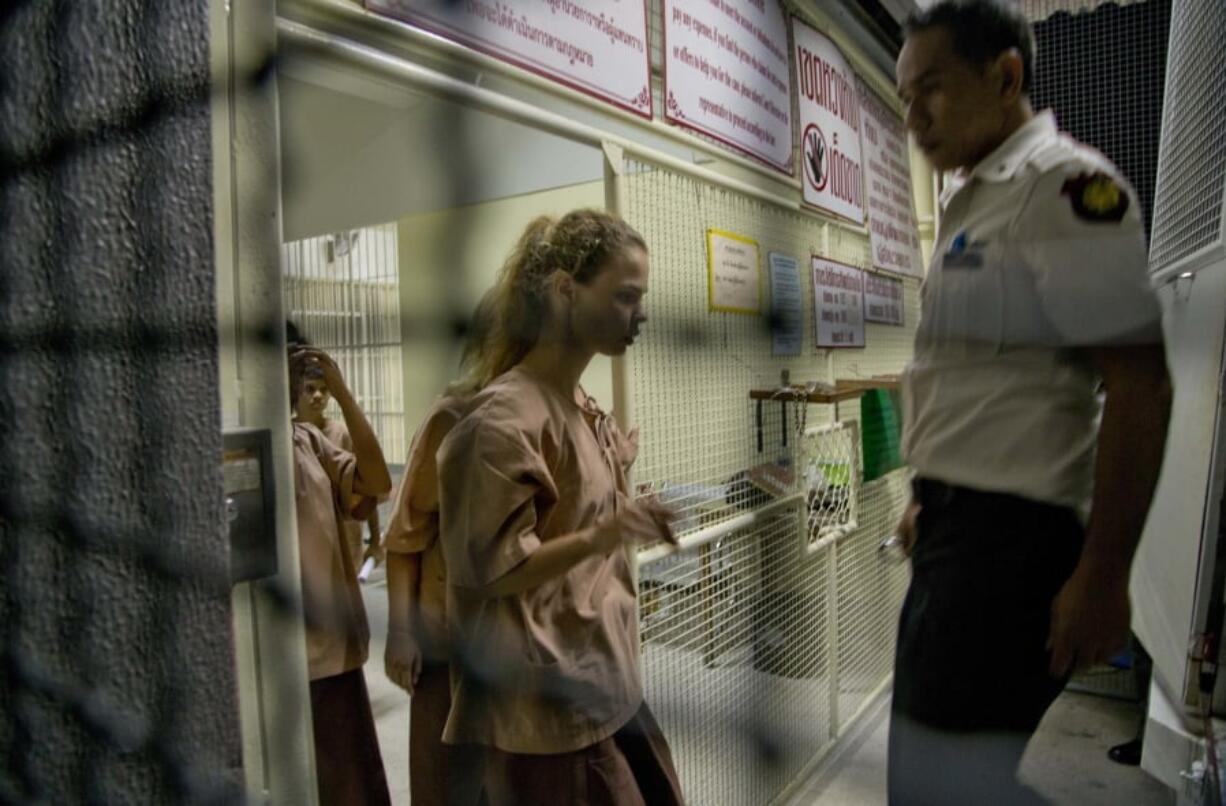 Anastasia Vashukevich, centre, walks into a prison transport vehicle outside a courthouse in Pattaya, south of Bangkok, Thailand, Tuesday, April 17, 2018. Russian sex guru Alexander Kirillov and about six of his followers, including Vashukevich who claims to have evidence of Moscow’s interference in the 2016 U.S presidential election, have emerged briefly for a Thai court hearing after being held virtually incommunicado in an immigration jail.