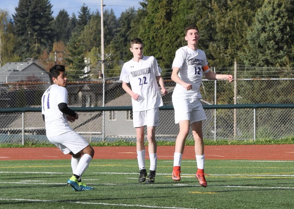 Senior Spencer Clark (12), sophomore Brandon Norton (22) and junior Marcos Hernandez, left, have helped the Heritage boys soccer team challenge for the 4A Greater St. Helens League title.