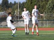 Senior Spencer Clark (12), sophomore Brandon Norton (22) and junior Marcos Hernandez, left, have helped the Heritage boys soccer team challenge for the 4A Greater St. Helens League title.