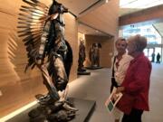 Visitors look at an installation on April 11 inside the James Museum of Western & Wildlife Art in St. Petersburg, Fla.