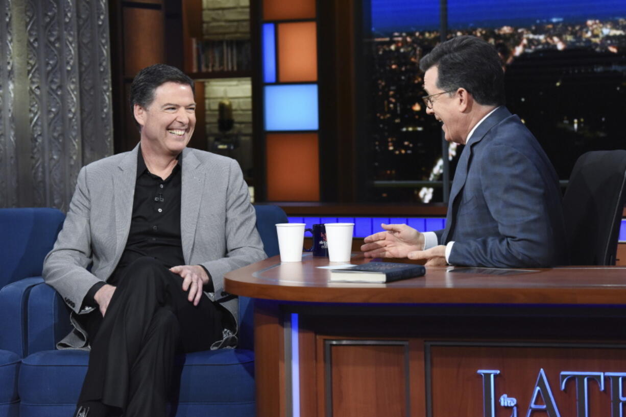 Former FBI Director James Comey, left, with host Stephen Colbert on “The Late Show with Stephen Colbert,” Tuesday, April 17, 2018 in New York.