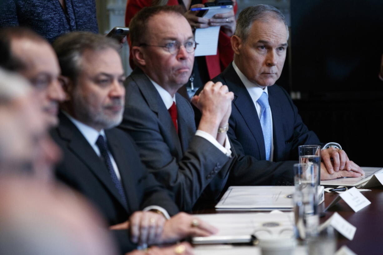 Environmental Protection Agency administrator Scott Pruitt, right, listens as President Donald Trump speaks during a cabinet meeting at the White House on Monday in Washington.