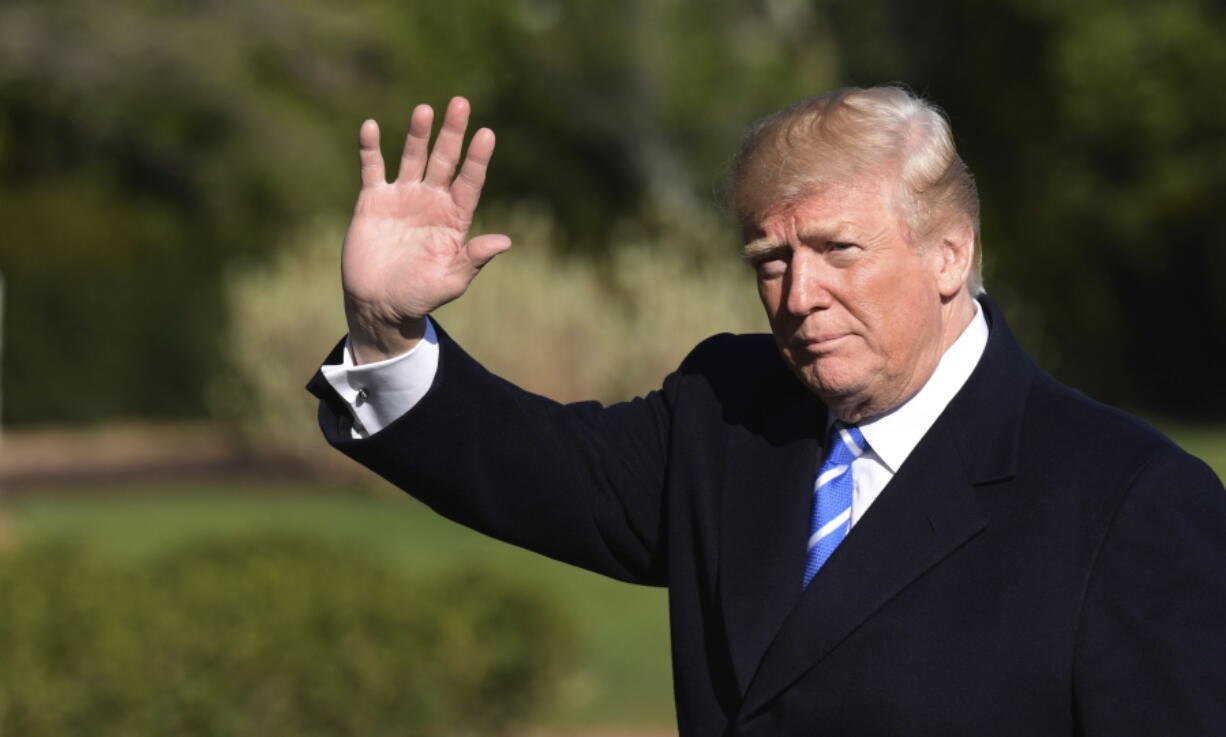 President Donald Trump waves as walks from Marine One on the South Lawn of the White House in Washington, Thursday, April 5, 2018, after returning from a trip to West Virginia.