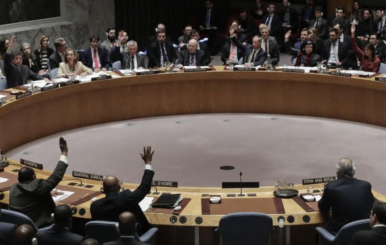 Members of the Security Council vote after presentations for a resolution drafted by the United States for an independent investigation on the use of chemical weapons in Syria during a Security Council meeting, Tuesday, April 10, 2018, at U.N. headquarters.