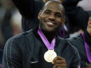 LeBron James celebrates after winning the Olympic gold medal at 2012 Summer Olympics, in London. LeBron James is putting himself in position to play in a fourth Olympics, and Kevin Durant and Chris Paul a third.