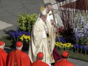 Pope Francis walks with the pastoral staff Sunday as he arrives to celebrates the Easter mass in St. Peter’s Square at the Vatican.