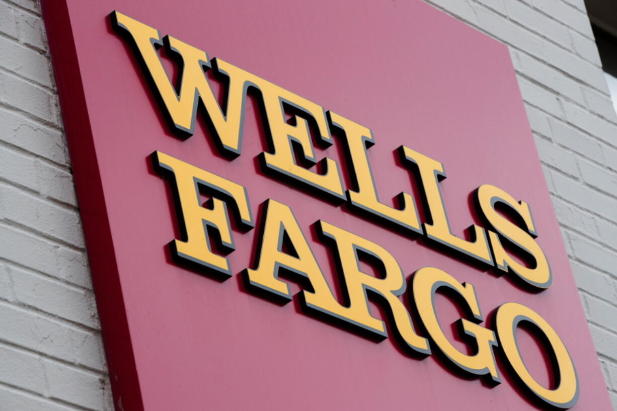 FILE - This Aug. 11, 2017, file photo shows a sign at a Wells Fargo bank location in Philadelphia. The New York Times and other news outlets are reporting Thursday, April 19, 2018, that federal regulators plan to fine Wells Fargo as much as $1 billion as early as Friday for abuses tied to its auto lending and mortgage businesses.