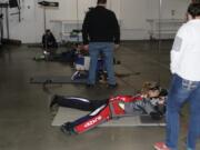 Kylie Delaney, 15, receives instruction at the firing range from shooting coach Katelyn Woltersdorf (right). Delaney recently competed in the Junior Olympics in Colorado Springs, Colorado.