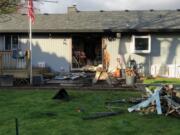 Camas-Washougal firefighters cut into the garage door at a home off of Northwest 27th Avenue in Camas on Feb. 14 to rescue a man trapped inside. Fire crews rescued a 70-year-old man and his two dogs from the fire.