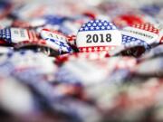 A 2018 Election Vote button on a pile of other buttons