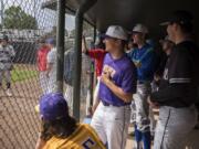 Members of the National League chat as they watch the first inning during the first Senior All-Star Game at Propstra Stadium in Vancouver on Wednesday, May 30, 2018.