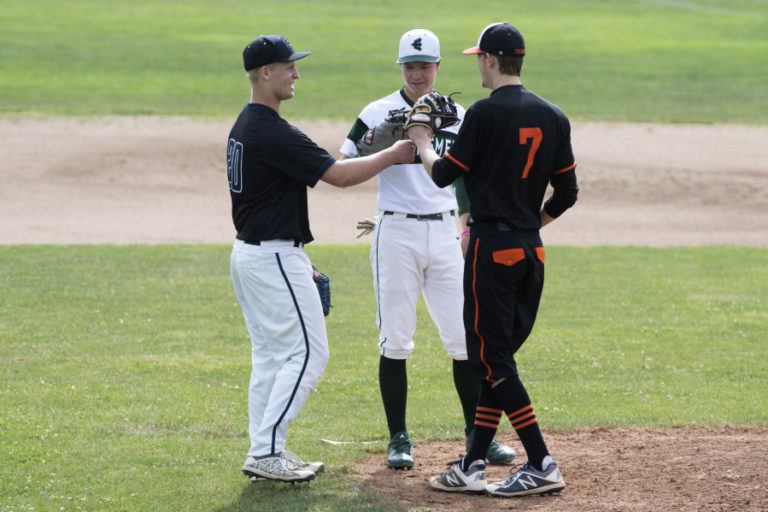 Skyview’s Michael Lundgren, 20, left, Evergreen’s Tommy Snyder, 2, and Battle Ground’s Tyler Russell, 7, meet at the pitchers mound during the first Senior All-Star Game at Propstra Stadium in Vancouver on Wednesday, May 30, 2018.