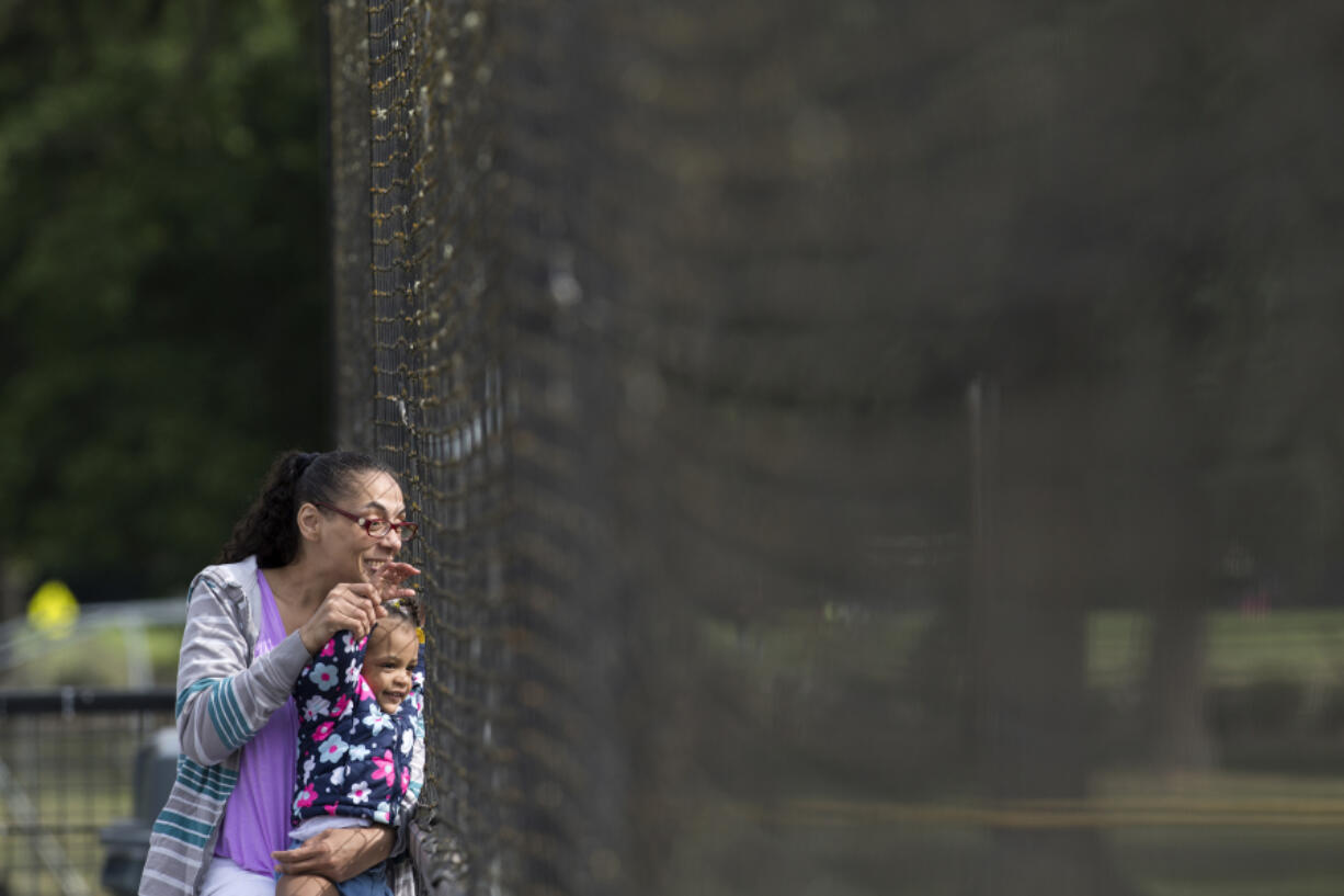 Nieashia Bickham and her daughter Domillyanah Hall, 1, both of Vancouver, cheer on Nieashia’s nephew during the first Senior All-Star Game at Propstra Stadium in Vancouver on Wednesday, May 30, 2018.