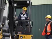 CAM Academy freshman Sadie Brackeen, left, learns to operate an excavator at the Youth Employment Summit in April. More than 700 students could meet with 30 companies there that have many job openings in today’s growing economy.