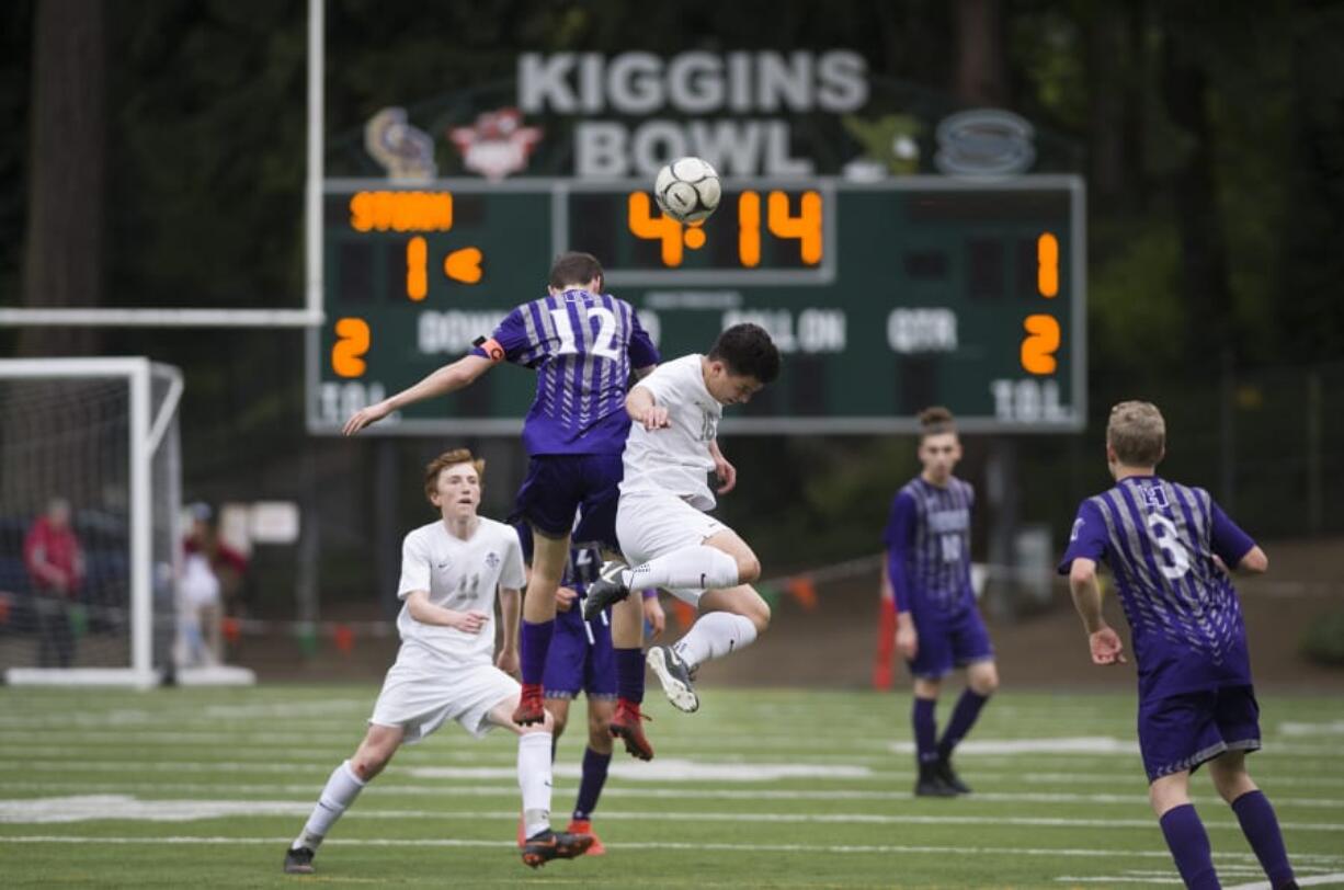 Heritage’s Spencer Clark (12) and Skyview’s Seth Yoshinobu (16) attempt to head the ball during the 4A GSHL boys soccer match at Kiggins Bowl.