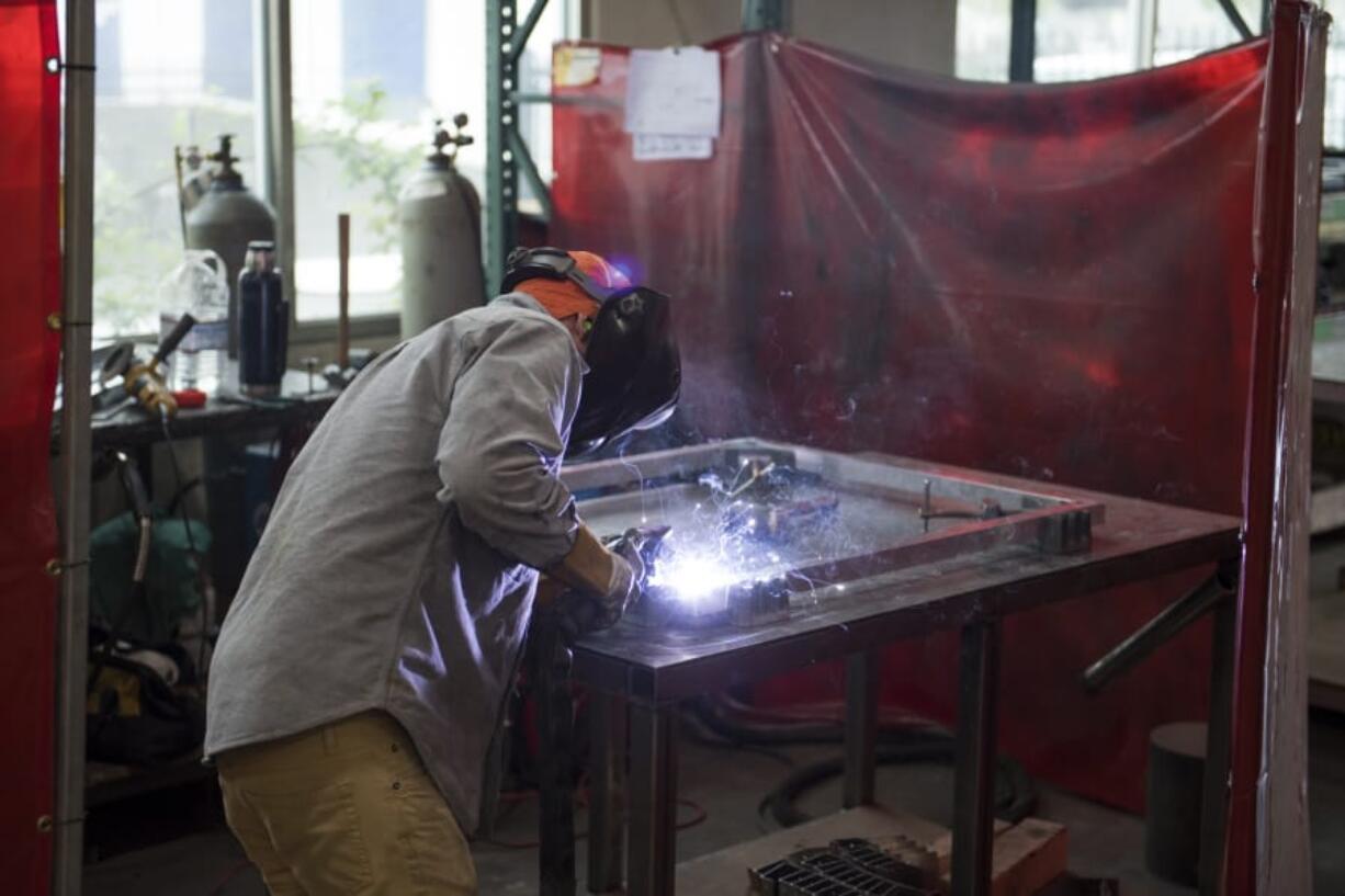 Josh King of Vancouver welds together equipment made by screen printing company Ryonet Corp. The Vancouver company sells its equipment mainly to other businesses, as well as do-it-yourselfers.