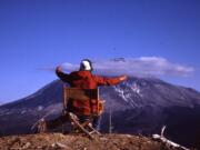 From a chair overlooking Mount St. Helens, Harry Glicken “conducts” bursts from the volcano on May 17, 1980. Glicken was scheduled to be there the following morning, but David Johnston took the shift. (Carolyn Driedger/U.S.