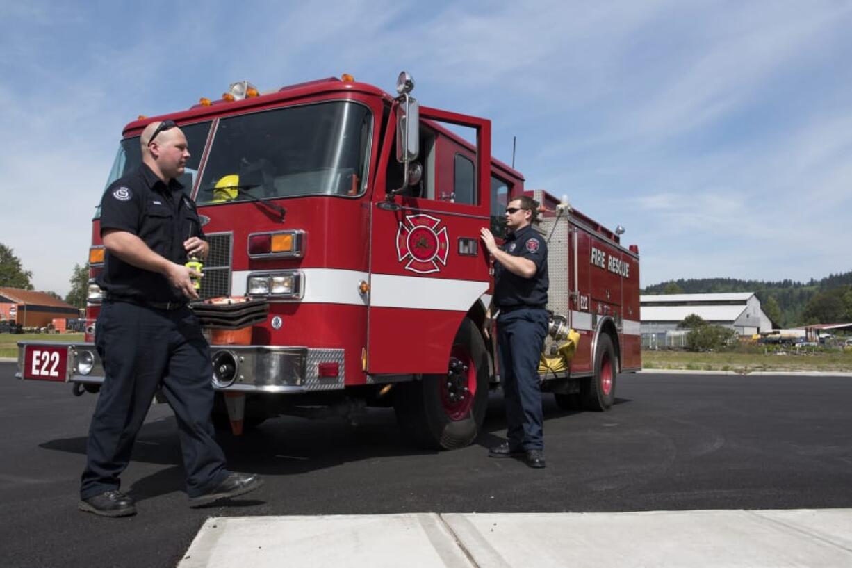 Clark County Fire & Rescue firefighter and paramedic Nick Maunu of Vancouver, left, and firefighter Greg Pera of Woodland arrive at the new fire station in Woodland after responding to a call. The two were part of the original crew who worked out of the old fire station when it went to 24-hour service in 2010, and worked one last shift at the station before it closes.