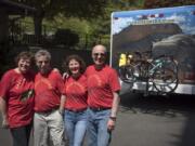 Solange Cyr, left, and her husband Edward Collister, both of Quebec City, and Lilly Boulianne and her husband Dave Halstead, right, both of Vancouver, stand Friday in front of the RV that Cyr is driving cross-country while the other three ride their bicycles.