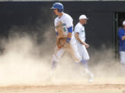 Mountain View infielder Quinn Rooks reacts to scoring against Yelm in a 3A bi-district baseball tournament game at Propstra Stadium.