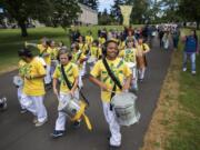 The Hough Elementary School after school program Youth Escola de Samba drum and march together during the Children's Cultural Parade at Fort Vancouver National Historic Site on Friday. The National Park Service, the Evergreen School District, and the Vancouver School District came together for the annual event to support local students and celebrate the region's historical diversity.