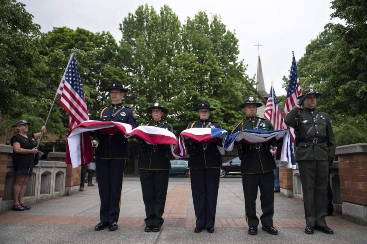 A multi-agency color guard presented and raised the flag during the Law Enforcement Memorial Ceremony outside the Clark County Public Service Center in Vancouver on Thursday, May 17, 2018.