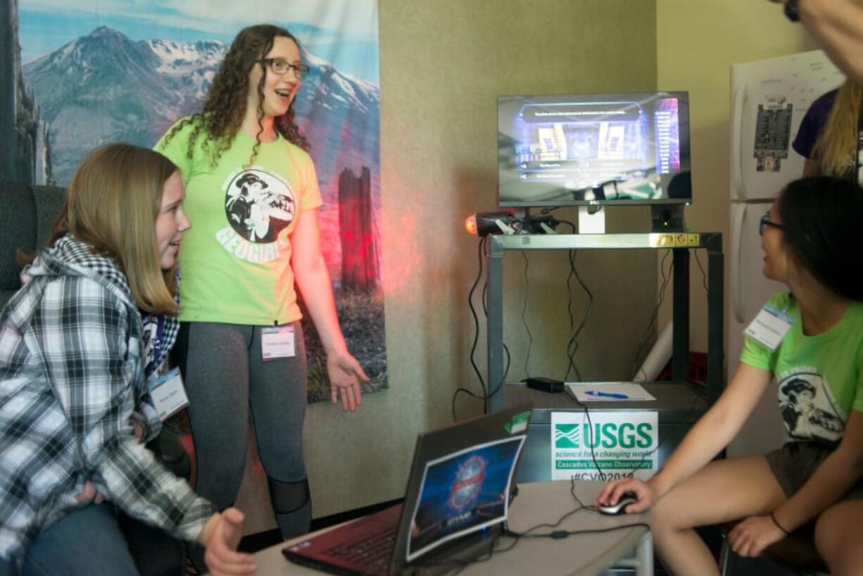 From left: GeoGirls Kenna Owens, Christina Deming, and Marquesa Calderon moderate a round of “Who Wants to be an Volcanologist!” as part of an open house at the USGS Cascade Volcano Observatory in Vancouver on Saturday, May 12. The center opened its doors to the public just days before the anniversary of the 1980 Mount St. Helens eruption.