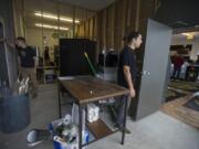 Main Street Marijuana co-owners Jason Keller, left, and Adam Hamide stand in an employee area soon to be remodeled. The store took over the 2,000-square-foot shop next door and plans to expand its showroom.