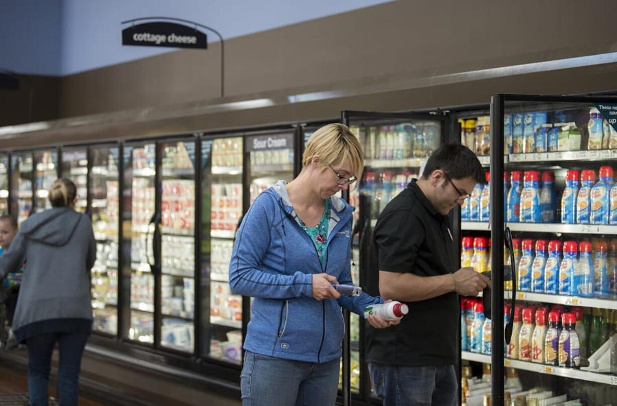 Camas resident Melissa Hansen uses a hand-held scanner to keep track of her grocery purchases at Fisher’s Landing Fred Meyer in east Vancouver. The use of the scanners is one of a few new initiatives the grocery chain is introducing to keep pace with an evolving industry.