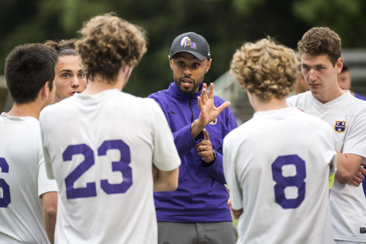 Columbia River coach Filly Afenegus talks with his team during half time at the first round of the Class 2A state playoffs at Kiggins Bowl in Vancouver on Wednesday, May 16, 2018.