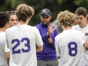 Columbia River coach Filly Afenegus talks with his team during half time at the first round of the Class 2A state playoffs at Kiggins Bowl in Vancouver on Wednesday, May 16, 2018.