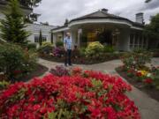 Jim Mains of the Ed and Dollie Lynch estate pauses for a photo outside the late philanthropists’ former home. At 4712 N.W. Franklin St., Vancouver, the 12,000-square-foot home is one of 20 high-end homes open to the public on Sunday.