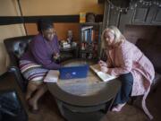 Carol Parker Walsh with Evolve Image Consulting, left, meets with client Twila Kaye at Di Tazza in southeast Vancouver. Walsh started her consulting and coaching business after a serious auto accident and other personal challenges.