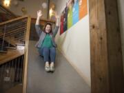 Hubb President and CEO Allison “Allie” Magyar glides down the office slide at the Hubb offices in Vancouver. The Hubb offices include a gym, napping pods, kombucha on tap, a large communal workspace and an office slide. Magyar believes this type of work environment is beneficial to employee satisfaction and productivity.