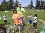 Washougal: Gause Elementary School Principal Renae Burson and physical education teacher Mark Bauer are sprayed with aerosol string by Cecilia Goodling’s kindergarten class to celebrate the class’ efforts during a fundraiser for the American Heart Association.