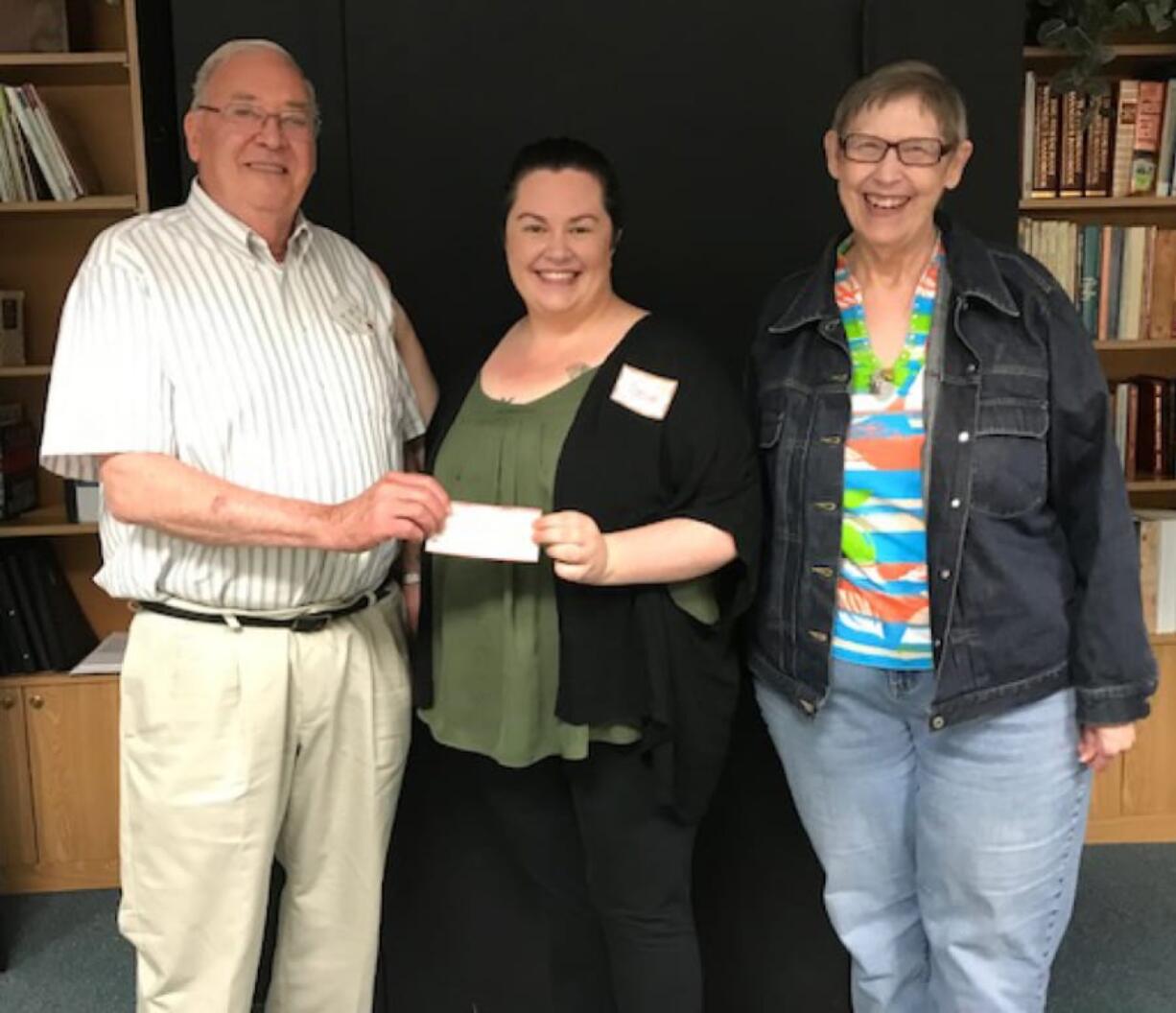 Esther Short: Southwest Washington School Retirees Organization treasurer Marty Erickson, from left, Cassie Sorensen, of the Homestead shelter, and Jody Bugg, co-president of the retirees organization, which donated $500 to Sorensen’s literacy room project at the shelter.